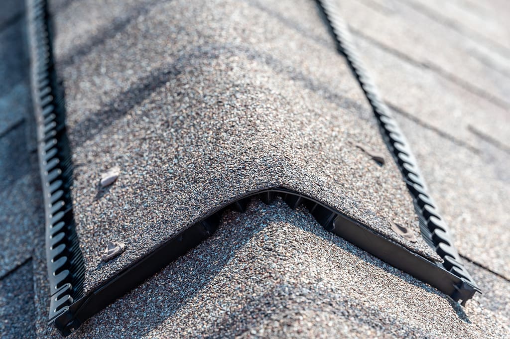 Ridge cap vent installed on a shingle roof typical Ridge cap vent installed on a shingle roof for passive attic ventilation