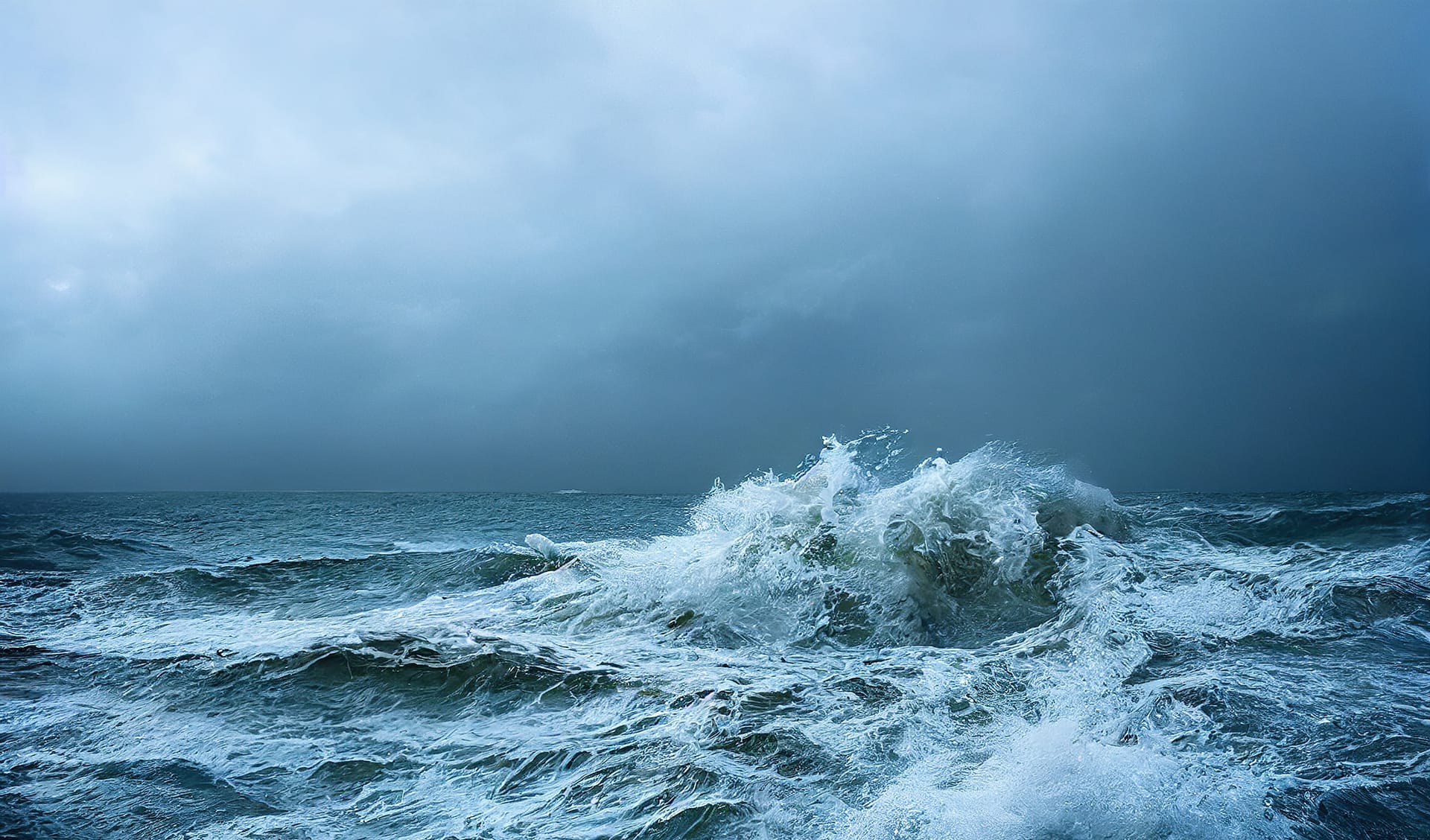 sea wave during storm in the ocean with big clouds and rain.