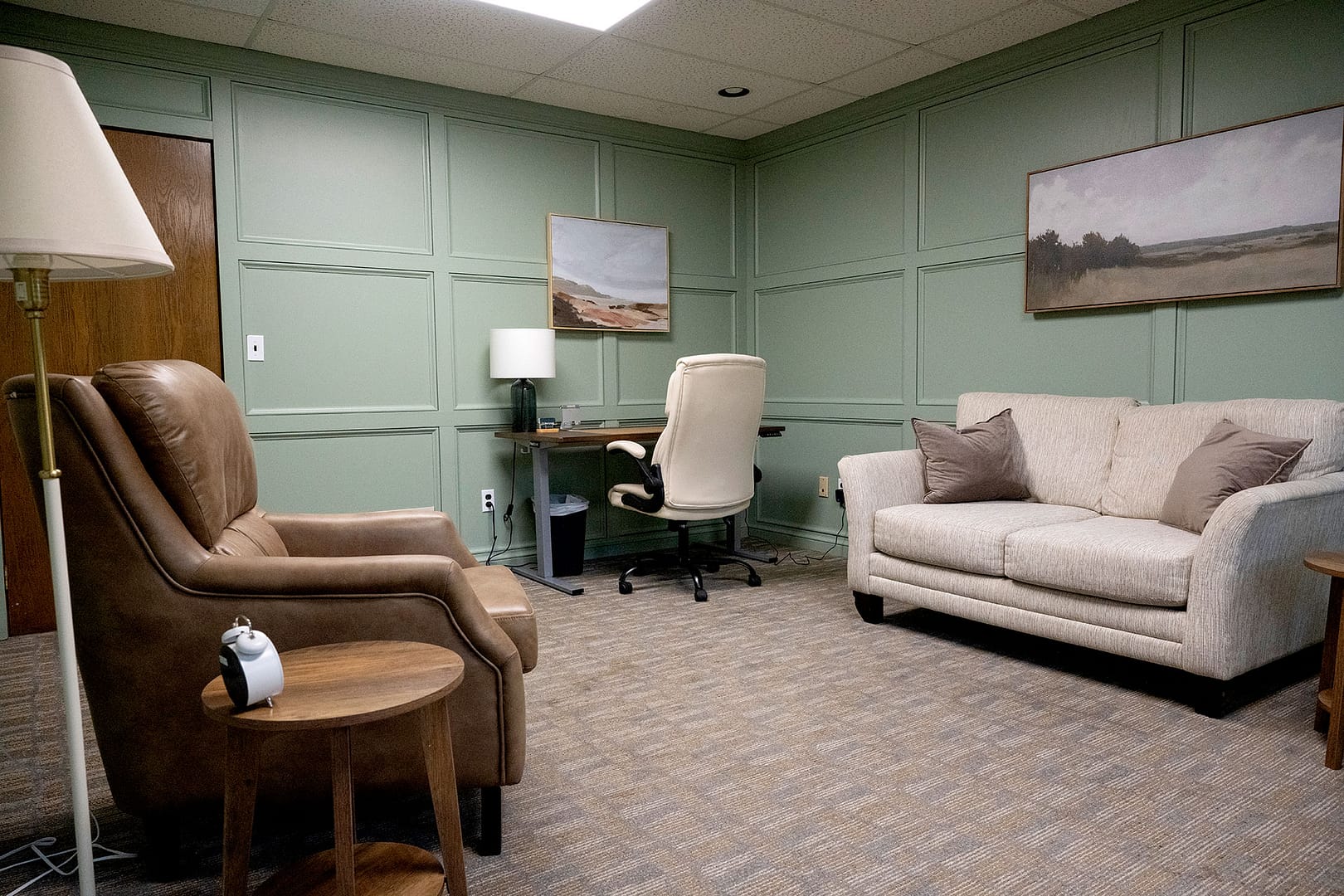 Robintek Rentals office 303 desk area, couch and chair in large office space