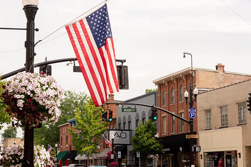 buildings in uptown westerville ohio with flag in forground