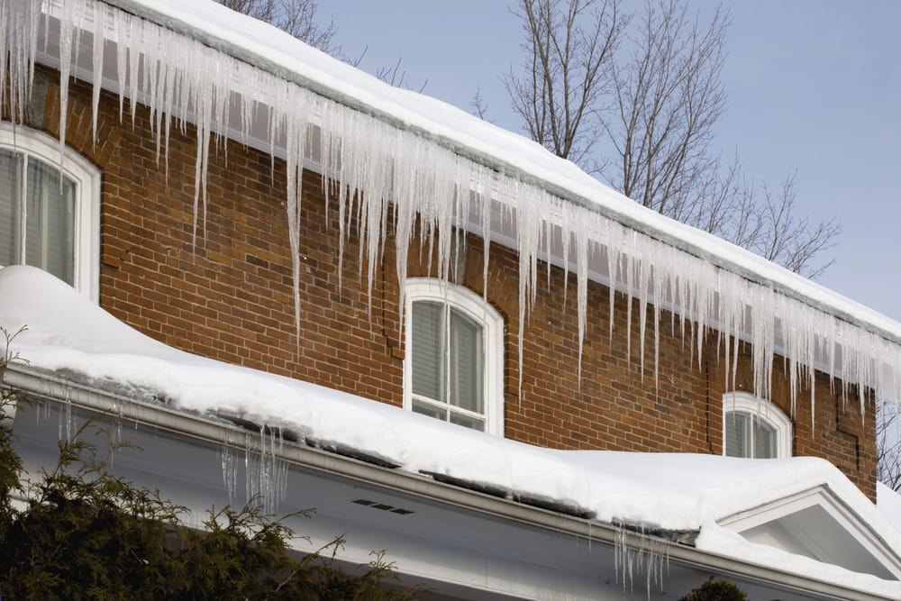 Icicles Hanging Off Rain Gutters showing there are ice dams in the gutters