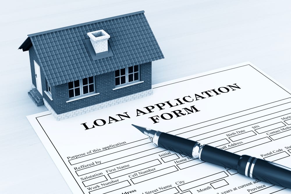 common options for financing a roof include a loan application form shown here with a pen