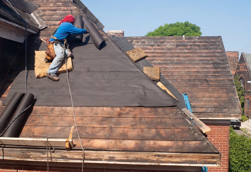 a roofer replacing felt on a roof, emphasizing The Most Overlooked Roof Problems