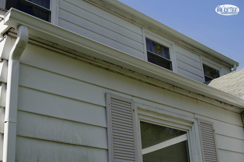 The image shows a gutter system on a house.