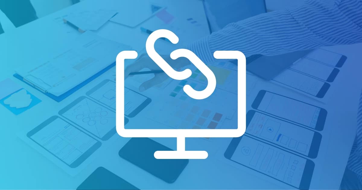 desktop with link icon over background of website design elements spread over a table