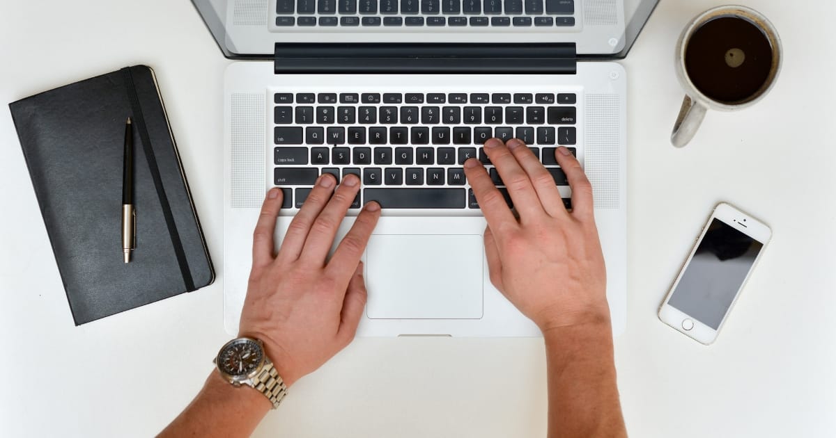 DIY website upgrades mans hands typing on laptop