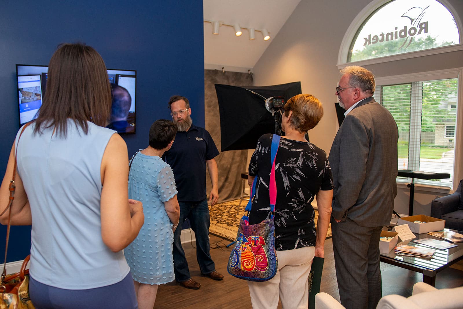 Team members chat with visitors during the Robintek Open House