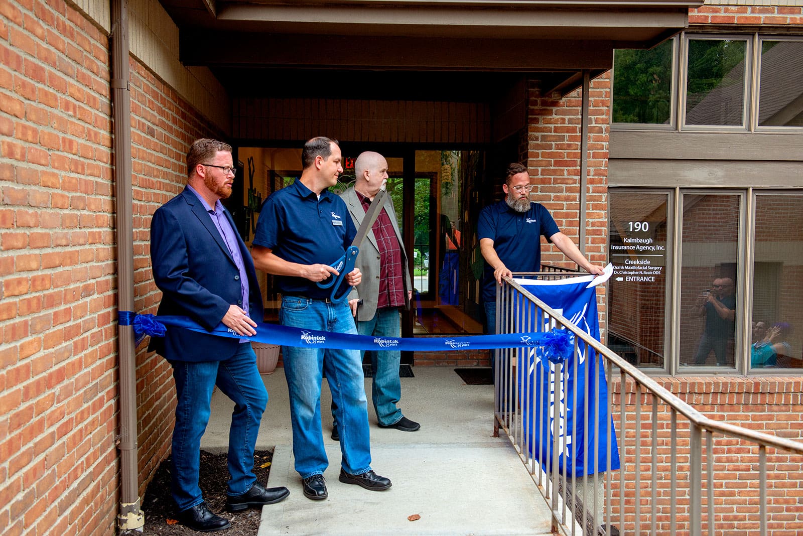 Robintek President Joe Jorgenson speaks during the ribbon cutting at the new Robintek Offices
