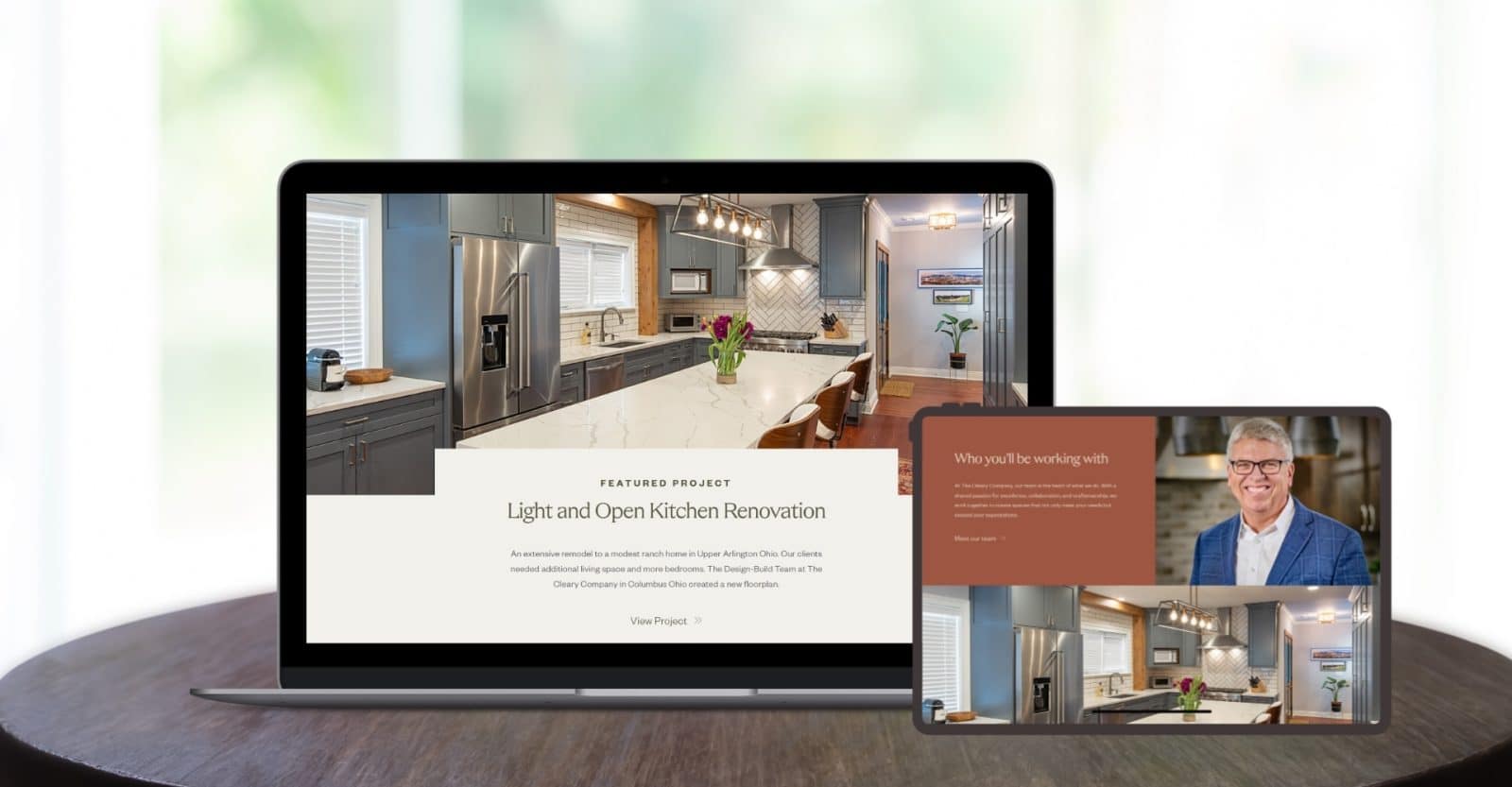 Cleary Co homepage design shown on laptop and tablet sitting on wooden table