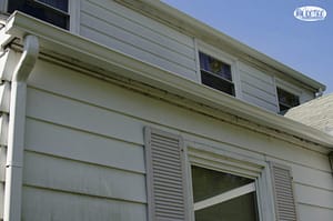 The image shows a gutter system on a house.