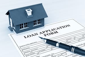 common options for financing a roof include a loan application form shown here with a pen