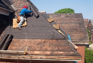 a roofer replacing felt on a roof, emphasizing The Most Overlooked Roof Problems
