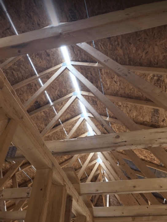 photo of a ridge vent that is new, and letting in light from above as you are looking up into the roof