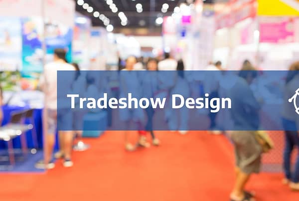 Tradeshow Design text and pen icon over out of focus crowded tradeshow background