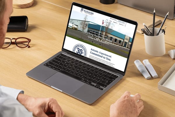 Breckenridge Paper and Packaging homepage pulled up on a laptop while a man looks at it